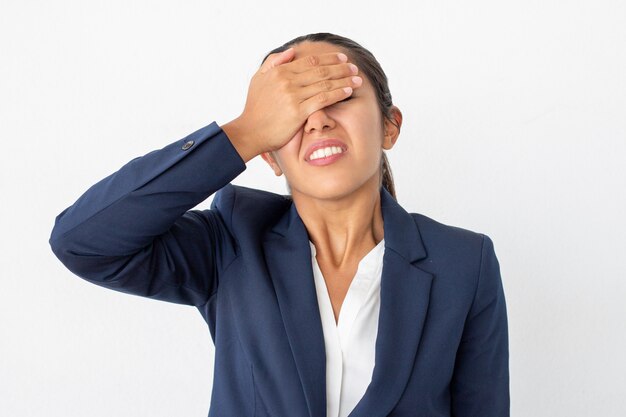 Disappointed businesswoman with hand on face