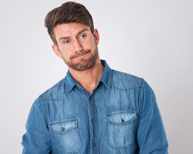 disappointed man wearing a denim shirt