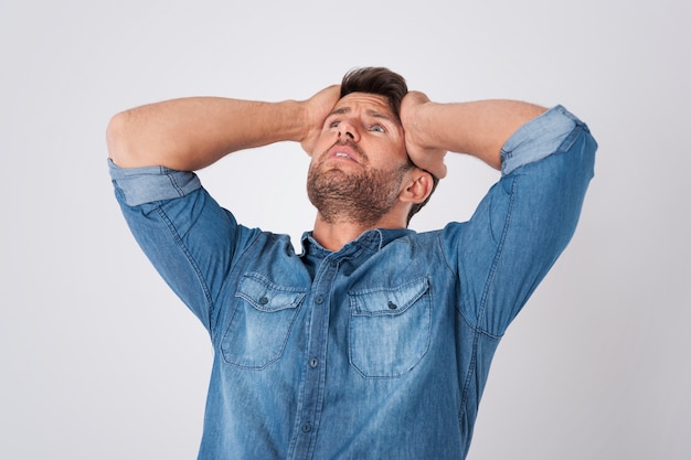 disappointed man wearing a denim shirt