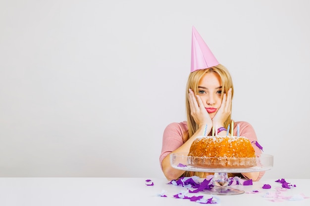 Disappointed woman with birthday cake