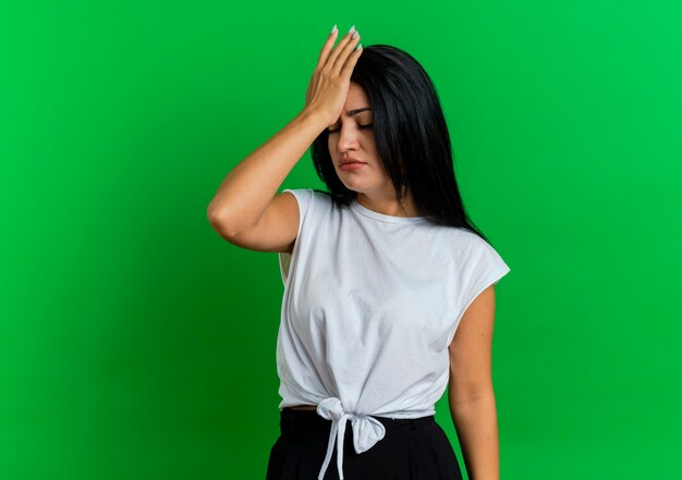 Free photo disappointed young caucasian woman puts hand on forehead