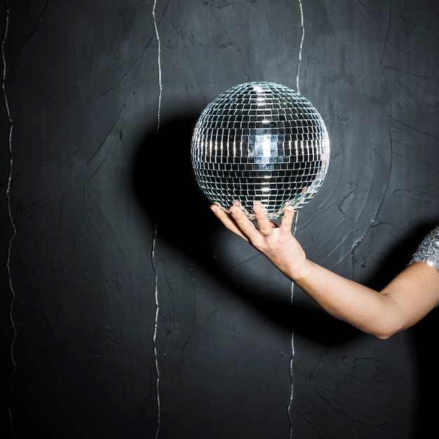 Disco ball on woman's hand 