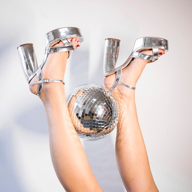 Free photo disco composition of legs and ball