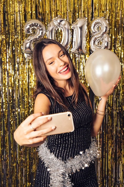 Free photo disco girl taking selfie on new year celebration