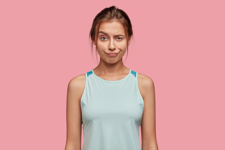 Free Photo discontent caucasian woman raises eyebrow, pouts lips