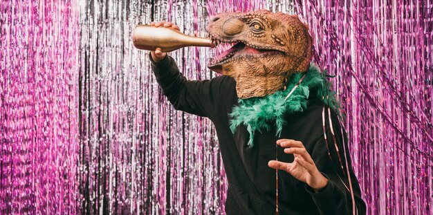 Free photo disguised man drinking champagne at party