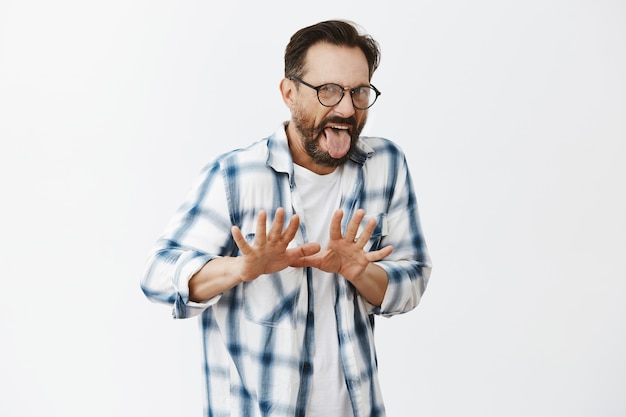 Disgusted bearded mature man posing