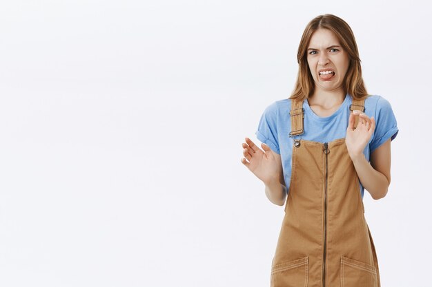 Disgusted girl showing tongue from aversion and dislike