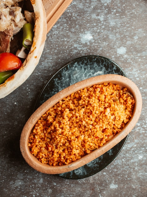 dish with bulgur with tomato sauce