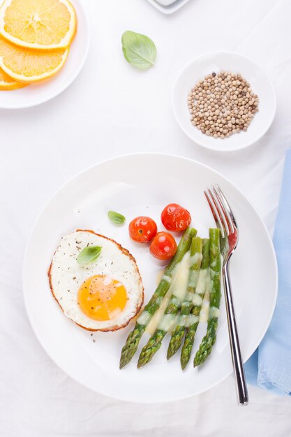 Dish with fried eggs and asparagus