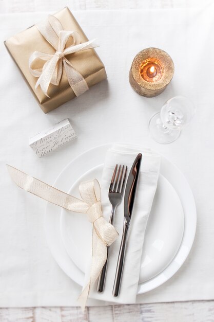 Dish with well-decorated cutlery with a lit candle