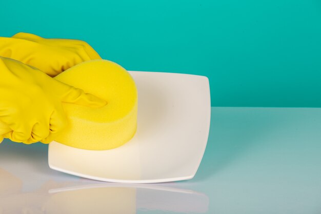 dishwasher wearing yellow gloves on a blue .