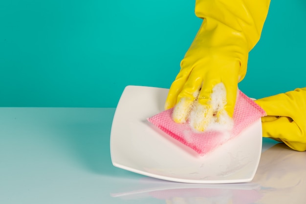 dishwasher wearing yellow gloves on a blue .