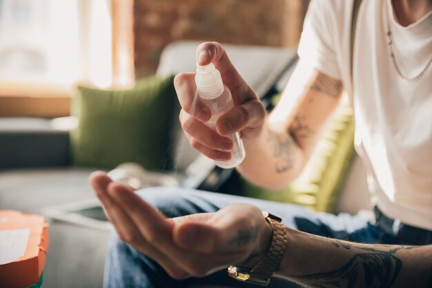 Disinfecting. Man studying at home during online courses, smart school