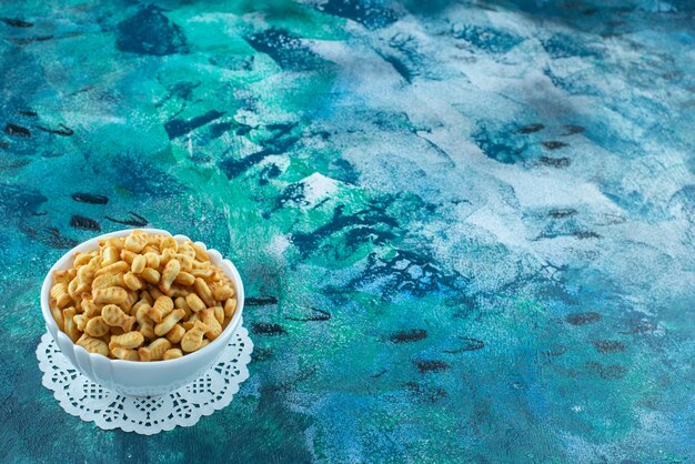 A display of cracker fish in a bowl on the marble surface