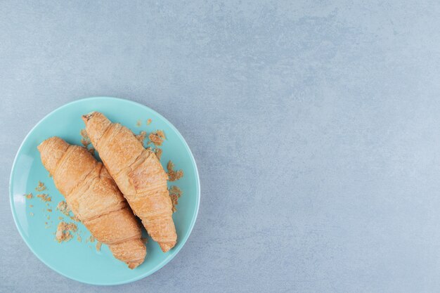 A display of croissant on plate on the marble background. High quality photo