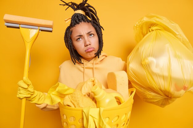 Displeased Afro American woman has combed dreadlocks looks sadly