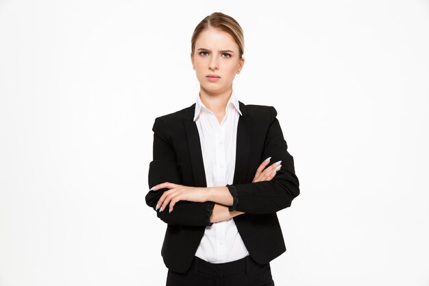 Displeased blonde business woman with crossed arms over white