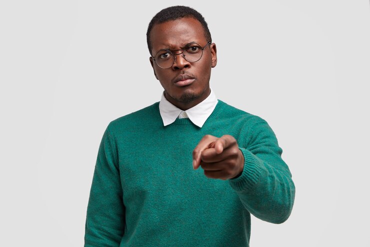 Free Photo displeased impassionate black man reproaches someone, points with index finger directly 