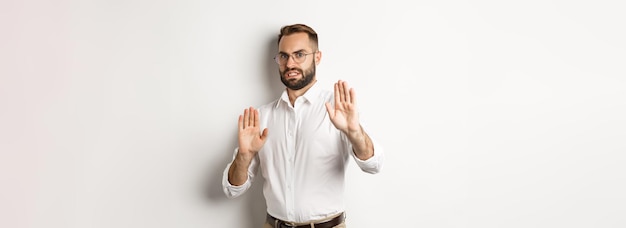 Free photo displeased man rejecting something disturbing showing stop sign and declining cringe from aversion s