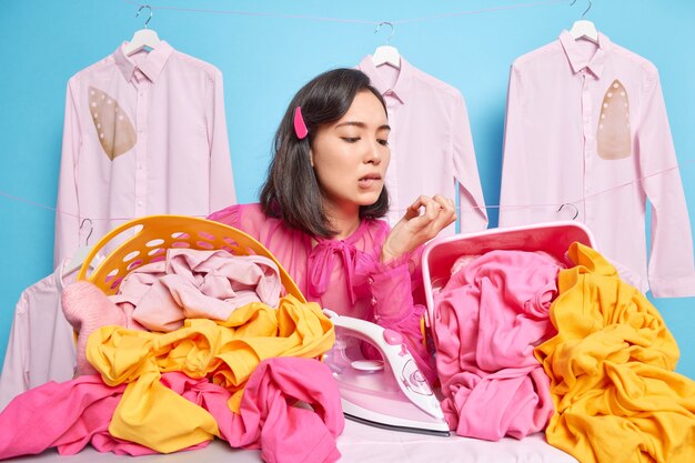 Displeased puzzled housewife does everyday household activities