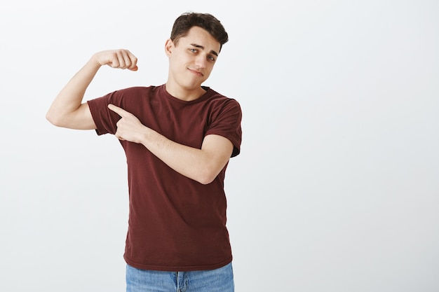 Displeased unsatisfied attractive male model in casual outfit