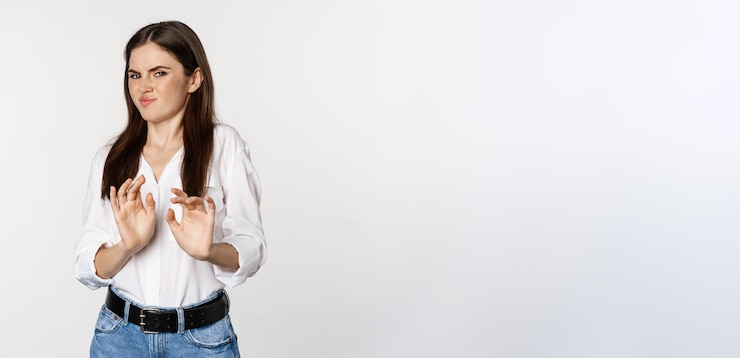 Free Photo displeased woman showing stop rejection gesture waving hands to decline refuse of something ugly sta