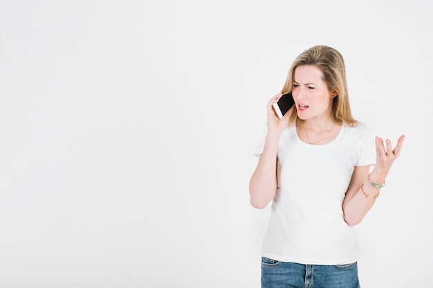 Displeased woman speaking on phone