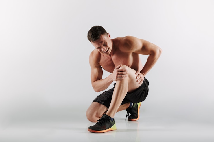 Free Photo displeased young sportsman have painful feelings in leg.
