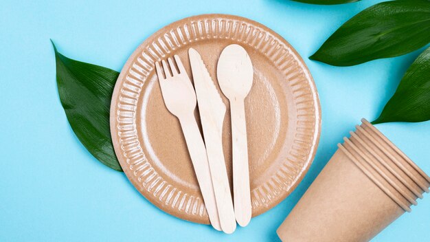 Disposable plates with cups and cutlery top view