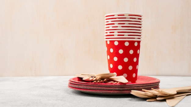 Disposable tableware pile of red with white dots cups