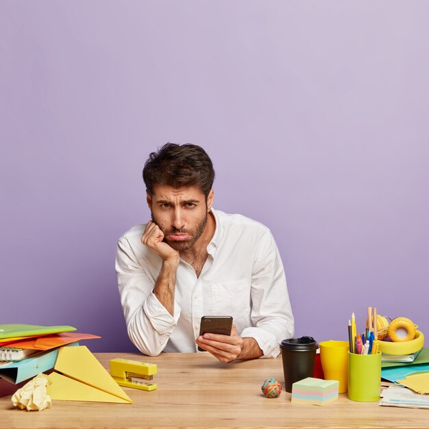 Dissatisfied employee sitting at the office desk