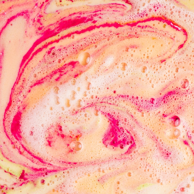 Dissolve of red and yellow bath bomb background