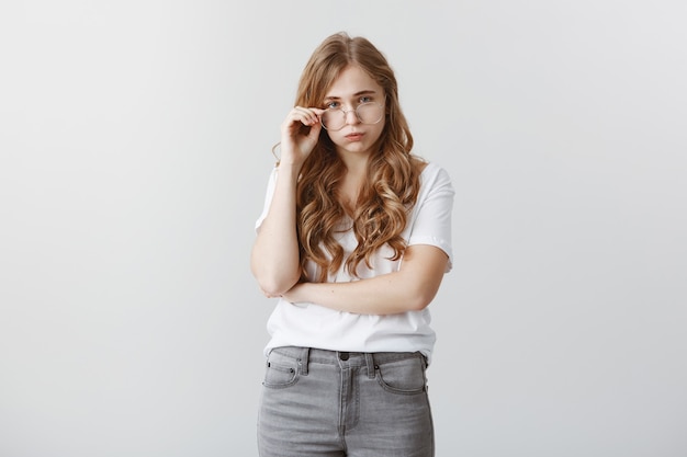 Distressed and exhausted blond female student exhale stressed, looking unamused