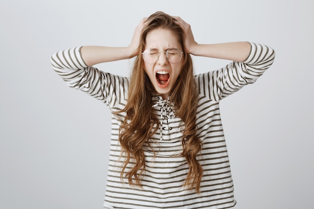 Distressed girl going insane, screaming and shaking head