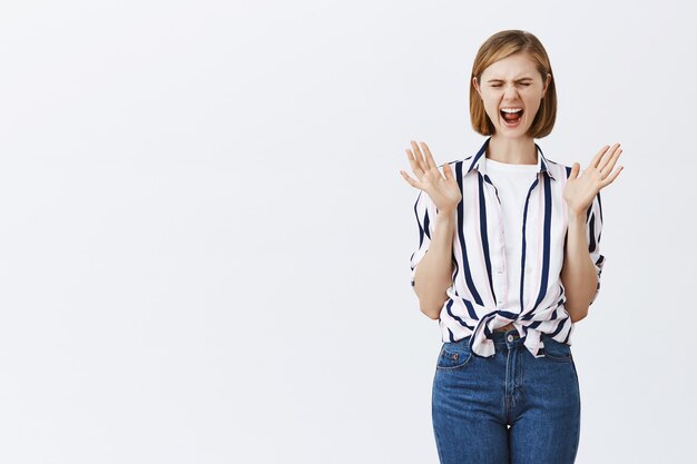 Distressed panicking woman screaming and looking stressed-out