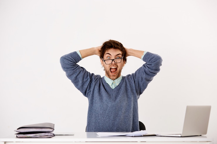 無料Photo 苦しめられた若い男性従業員、オフィスワーカーは仕事の燃え尽き症候群、感情的な内訳、オフィスで気が狂って、叫んで頭をつかんでいます