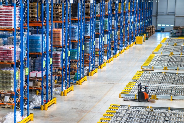 Distribution warehouse building interior and large storage area with goods on the shelf