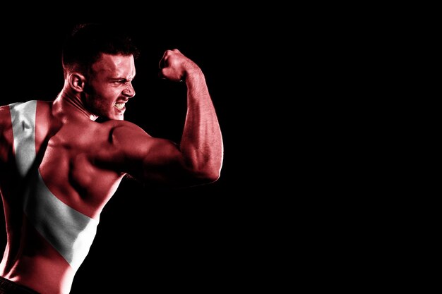 Diver Down flag on handsome young muscular man, black background