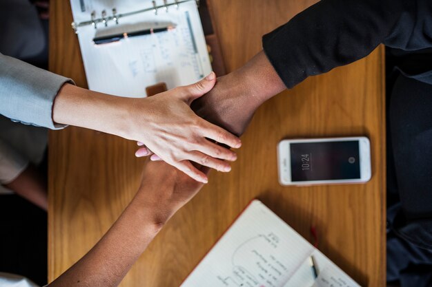 Diverse business team stacking hands