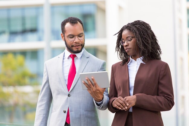 Diverse business team watching content on tablet