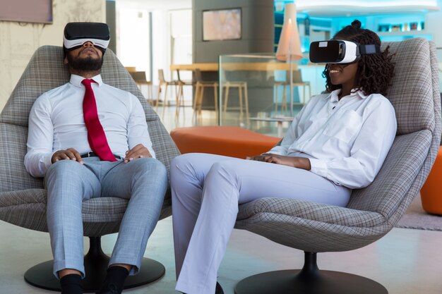 Diverse couple of colleagues enjoying VR experience