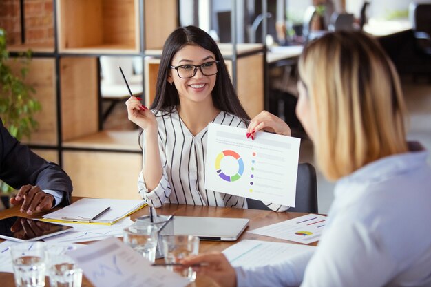 Diverse group of co-workers having casual discussion in office