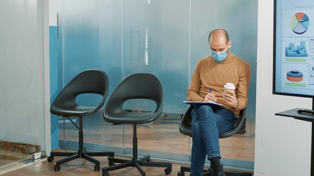 Diverse group of people waiting in queue to attend job interview, HR recruiter taking male applicant at recruitment meeting. African american man with cv and career opportunity.