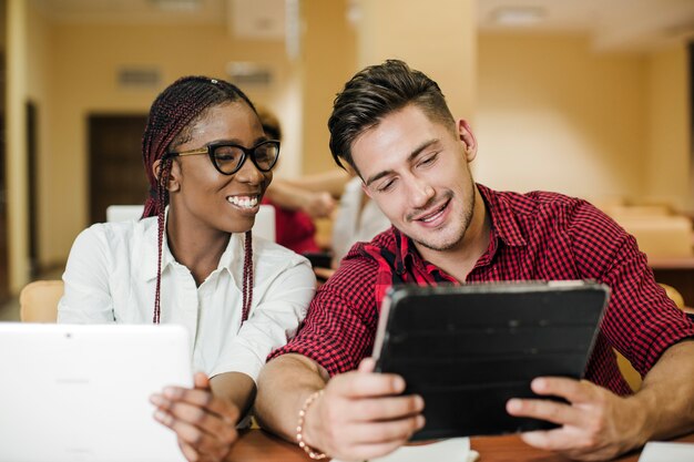 Diverse students watching tablet