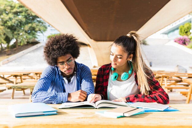 Diverse young couple studying together at university campus