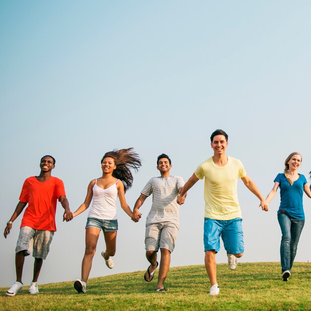 Diverse young people holding hands