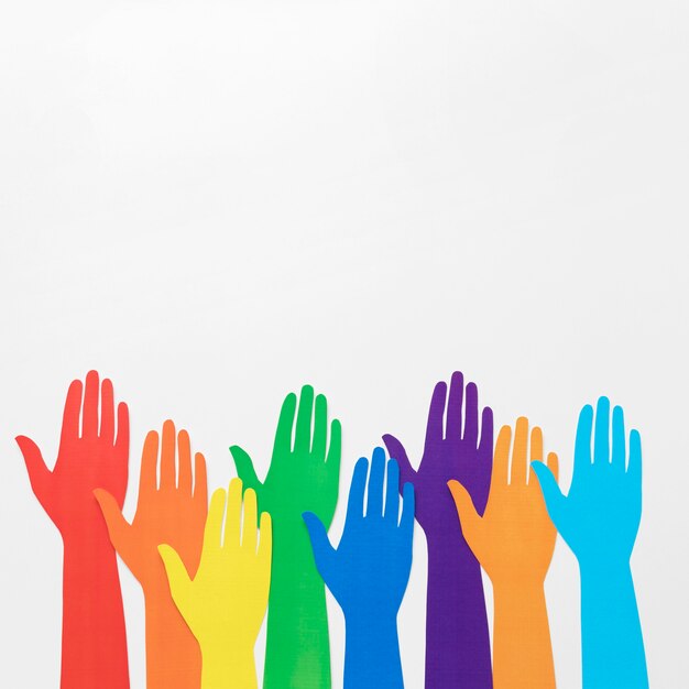 Diversity arrangement of different colored paper hands with copy space
