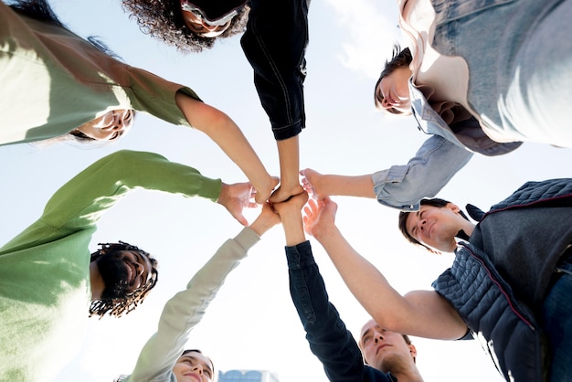 Free Photo diversity of people holding hands bottom view