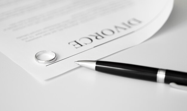 Divorce contract with rings on table